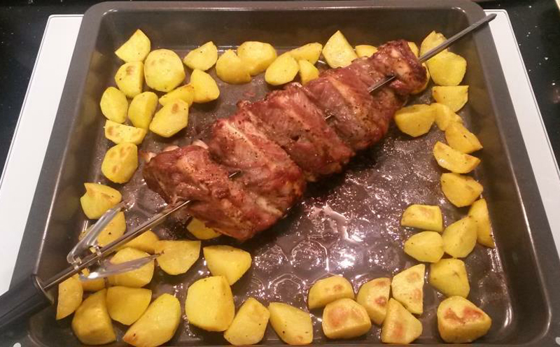 Pork ribs on the grill in the oven with potatoes and country-style recipe